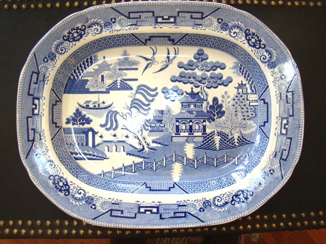 A large early 19rh century Blue Willow pattern serving platter by Lane End Pottery, circa 1830
